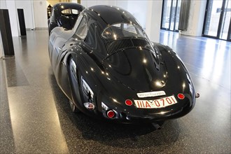 1939 PORSCHE TYPE 64 VW TYPE 60, rear view of a black Porsche sports car in a car exhibition,
