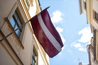 The flag of Latvia flies in the historic centre of Riga, Latvia, Europe