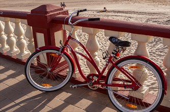 Red ladies' bicycle, balustrade on the beach of Bornos, Andalusia, Spain, Europe