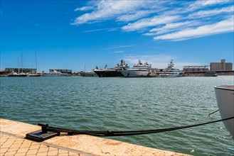 View of the marina of Tarragona with luxury yachts, clear blue sky and calm sea, Tarragona, Spain,