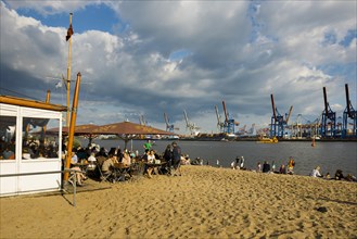 People on the beach, Strandbar Strandperle, Elbe beach, Hamburg harbour in the background,