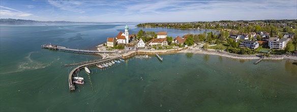 Moated castle peninsula with castle and parish church of St George on Lake Constance. Aerial photo,