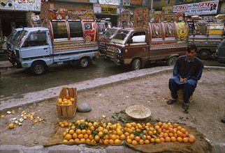 Street vendor, selling oranges, bus station, Pakistan, Asia