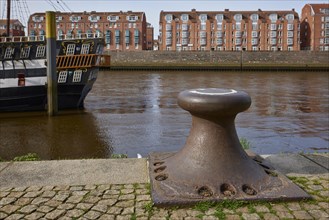 Bollards on the banks of the Weser and the houses on the Teerhof in Bremen, Hanseatic City, State