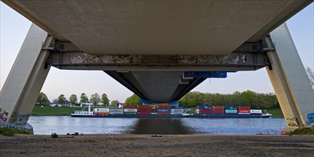 Container ship on the Rhine passes under the Fleher Bridge, Neuss, Lower Rhine, North