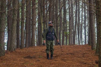 Fisherman walking in pine forest, Cambara do sul, Rio Grande do sul, Brazil, South America