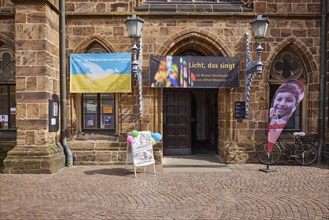 Entrance to Our Lady's Church with peace flag on the occasion of the war in Ukraine in Bremen,