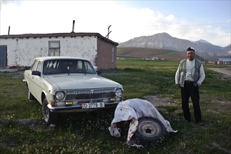 Old Volga car, owner of the car, house of the owner of the car, Alay valley, Kyrgyzstan, Asia