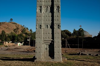 Stele, Aksum, Ethiopia. in the background, the dome of the New Church of Saint Mary of Zion