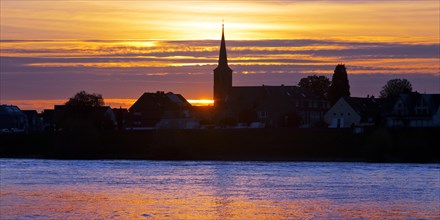 Rhine at sunset with the church of St Dionysius in Volmerswerth, Duesseldorf, Lower Rhine, North