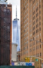 The One World Trade Centre can be seen at the end of a street canyon, Lower Manhattan, New York