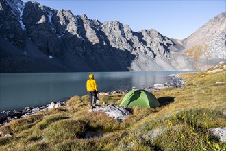 Hikers camping in the wilderness, mountain lake in the Tien Shan, Lake Ala-Kul, Kyrgyzstan, Asia