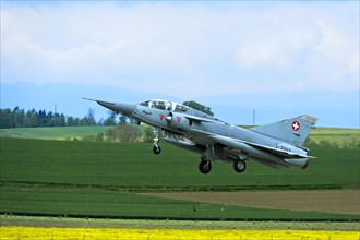 Swiss Air Force Mirage IIIDS two-seater fighter aircraft climbing, Payerne military airfield, Vaud,