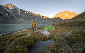 Hikers camping in the wilderness, mountain lake in the Tien Shan, Lake Ala-Kul, Kyrgyzstan, Asia