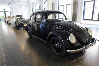 Classic black Volkswagen Beetle in a bright showroom, AUTOMUSEUM PROTOTYP, Hamburg, Hanseatic City