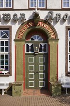 Entrance door of the Swan pharmacy in the city centre of Husum, district of Nordfriesland,