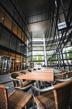 Modern cafeteria in a glass building with tables and chairs, Berlin, Germany, Europe