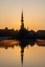 Sunrise on the Daugava River behind St Peter's Church, Riga, Latvia, Europe