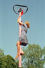 Girl climbing on maypole, barefoot, Heiligenthal, Lower Saxony, Germany, 20/06/1992, vintage,