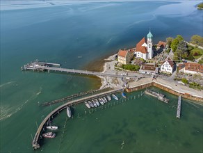 Moated castle peninsula with castle and parish church of St George on Lake Constance. Aerial view,