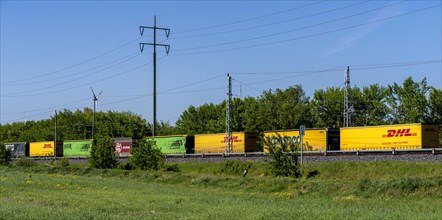Goods train on a railway line in the landscape of Berlin-Beech, Germany, Europe
