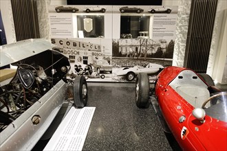 Model racing car next to historic racing car at an exhibition, AUTOMUSEUM PROTOTYP, Hamburg,