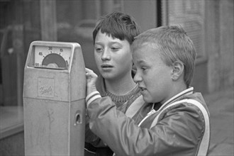 Two boys examining a parking meter, Bamberg, Upper Franconia, Bavaria, Germany, 26 October 1987,