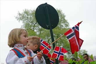 Little girl in traditional traditional costume waving a flag, folklore, bank holidays 17 May, Oslo,