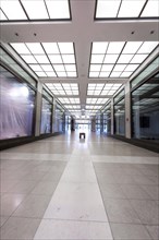 Empty hallway with symmetrical ceiling lights and a cool colour tone, Berlin, Germany, Europe