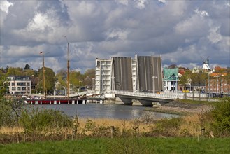 Sailing ship passes through open bascule bridge, Kappeln, Schlei, Schleswig-Holstein, Germany,