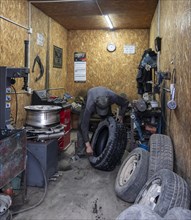 Workshop, man repairing a hole in a car tyre, Kyrgyzstan, Asia