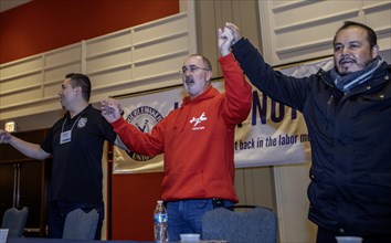 Chicago, Illinois, Shawn Fain (center), president of the United Auto Workers union, joins in