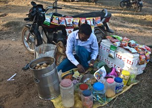 Man, selling snacks, motorcycle, rural market, West Bengal, India, Asia