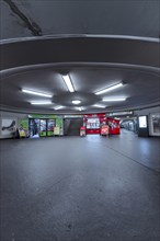 Empty underground railway hall with circular ceiling lighting and clear lines, Berlin, Germany,