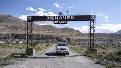 Car at the entrance to the ghost town of Enilchek in the Tien Shan Mountains, Ak-Su, Kyrgyzstan,