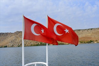 Two Turkish flags in the wind at the bow of a boat, Halfeti, Turkey, Asia