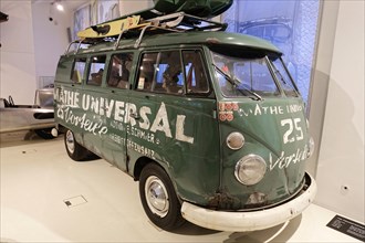 VW Transporter T1, retro Volkswagen bus with advertising lettering and roof luggage in a museum