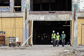 Detroit, Michigan, Workers leave the abandoned Fisher Body 21 auto factory. The building is being