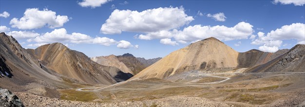 Mountain road through a colourful mountain landscape, view from the Chong Ashuu Pass, Tien Shan,