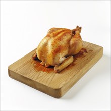 Roasted chicken on a wooden board against a white background, AI generated