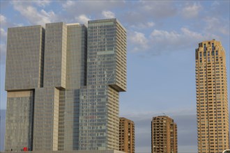 High-rise buildings in a modern city in sunlight with a cloudy sky, skyline of a modern city on a