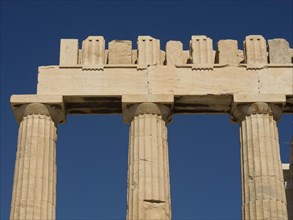 Ancient marble columns with a clear blue sky in the background, historical columns and ruins at an