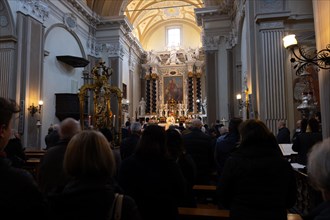 People Praying Inside the Church of San Nazzaro (Croglio) in Castelrotto, Ticino, Switzerland,