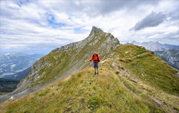 Mountaineer at Schoenjochl, mountain landscape at the ridge with green meadows, Obergailtal, Carnic