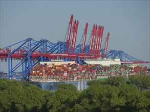 Large container harbour with astonishing amounts of stacked containers and cranes in the