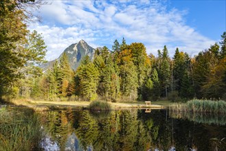 Idyllic view of a lake with reflection surrounded by autumn forest and mountains, Kernwald, Kerns,
