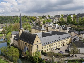 Panorama of a city with a central church and river surrounded by historic buildings and green hills