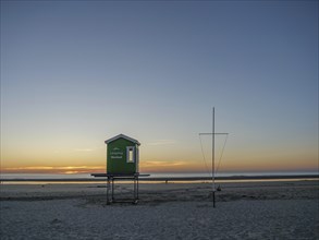 Beach scene at sunset with green beach hut and wide view, beautiful sunset on the beach of an