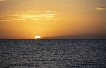 The sun sets behind the lake, sunset at Issyk Kul, Kyrgyzstan, Asia