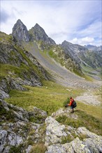 Mountaineer on a hiking trail at a saddle, pointed rocky mountain peaks Letterspitze and Steinwand